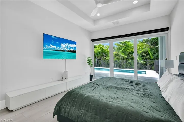Spacious primary bedroom offers pool access.