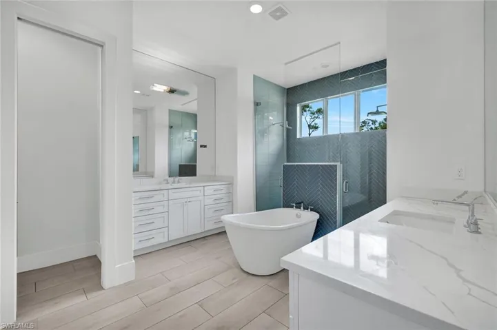 Primary bathroom features separate his and her sinks.