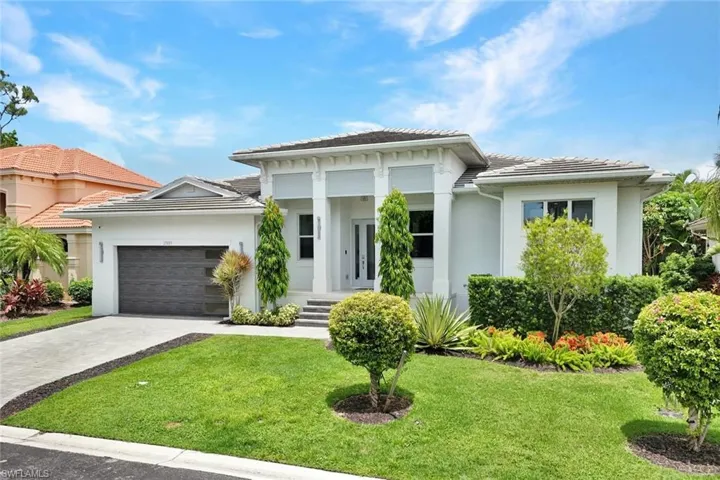 Welcome to 27085 Serrano Way! A STUNNING modern masterpiece just minutes from Downtown Bonita Springs featuring sleek architectural design, lush tropical landscaping, and an inviting entrance that sets the stage for luxury living.