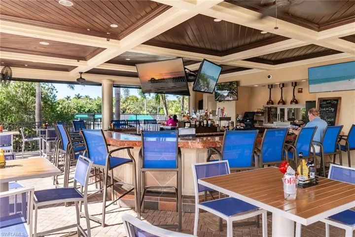 Open-air Tiki Bar with full dining, adjacent to pool and tennis.