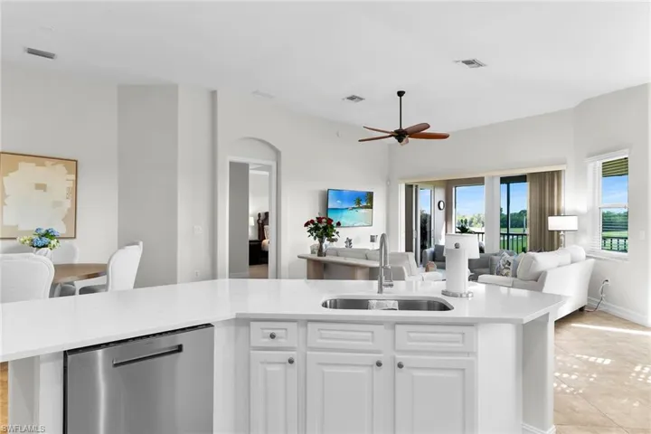 Open-concept, fully updated kitchen with brand-new quartz countertops, updated cabinetry, stainless steel appliances, and an expansive island—opening to beautiful, light-filled views beyond.