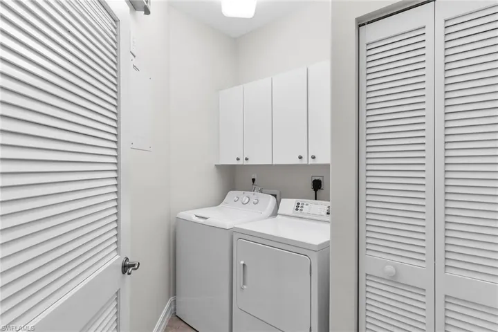 Laundry room featuring cabinet space and washer and dryer.