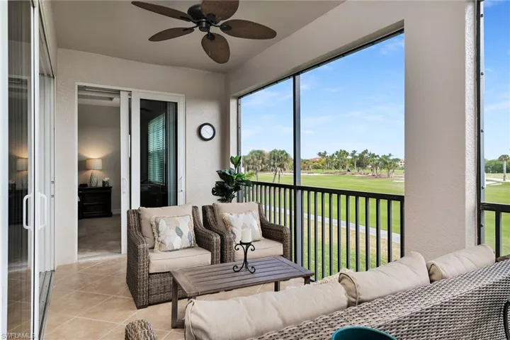 Screened lanai offering golf course views and ample space for outdoor seating.