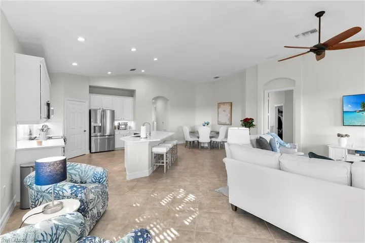 Open-concept living space featuring vaulted ceilings, recessed lighting, and seamless flow between the living area and the fully updated kitchen.