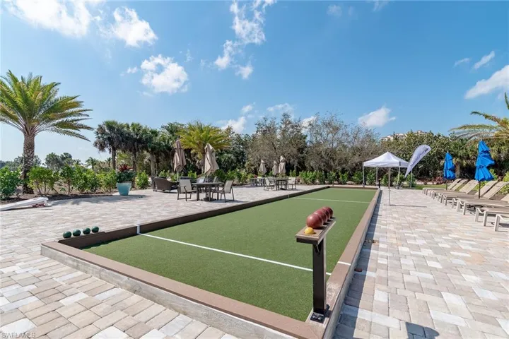 Surrounding community with a bocce ball area and a patio area