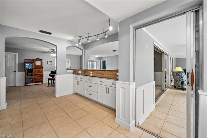 Kitchen opens to the enclosed lanai