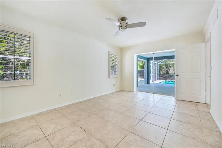 Spare room with ceiling fan, a healthy amount of sunlight, light tile patterned floors, and ornamental molding