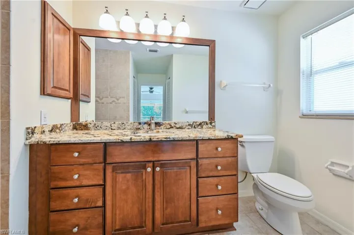Bathroom with tile patterned flooring, vanity, and toilet
