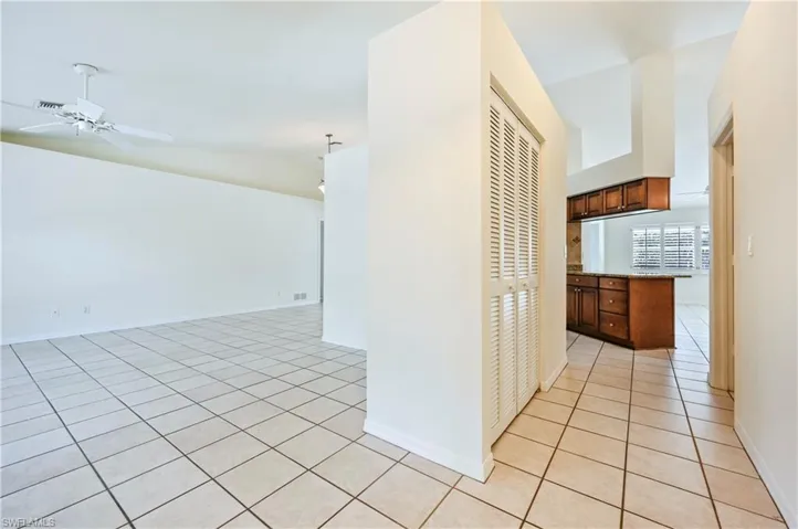 Hallway featuring light tile patterned floors