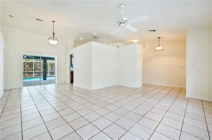 Tiled empty room featuring ceiling fan