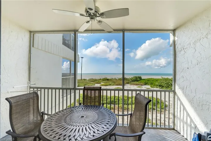 Sunroom featuring a water view and plenty of natural light