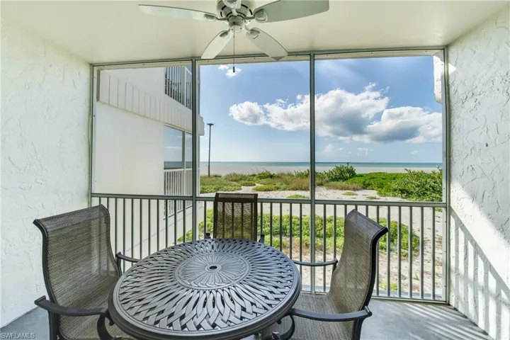 Sunroom / solarium featuring a water view