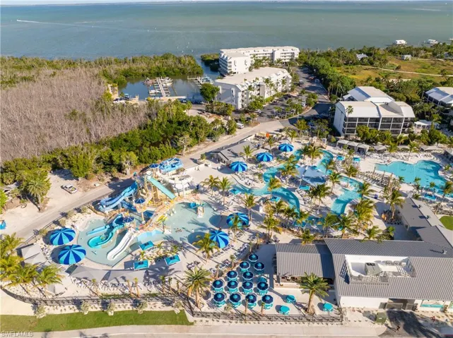 Bird's eye view of a pool and a nearby body of water