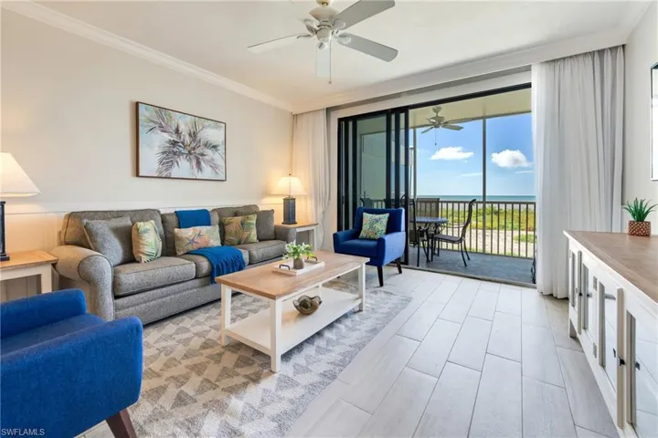 Living area featuring a water view and ornamental molding