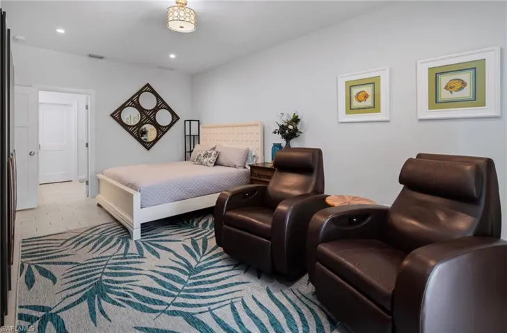 Bright interior space featuring light-toned walls, recessed lighting, and a decorative ceiling fixture