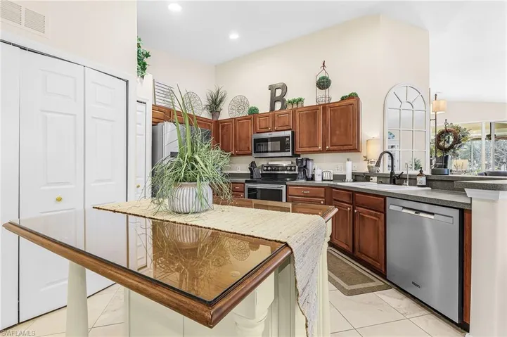 Pantry storage plus washer/dryer stating behind doors.