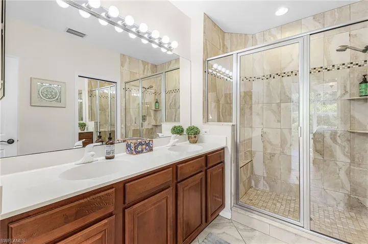 Twin sinks and a very spacious standup shower in the master bathroom