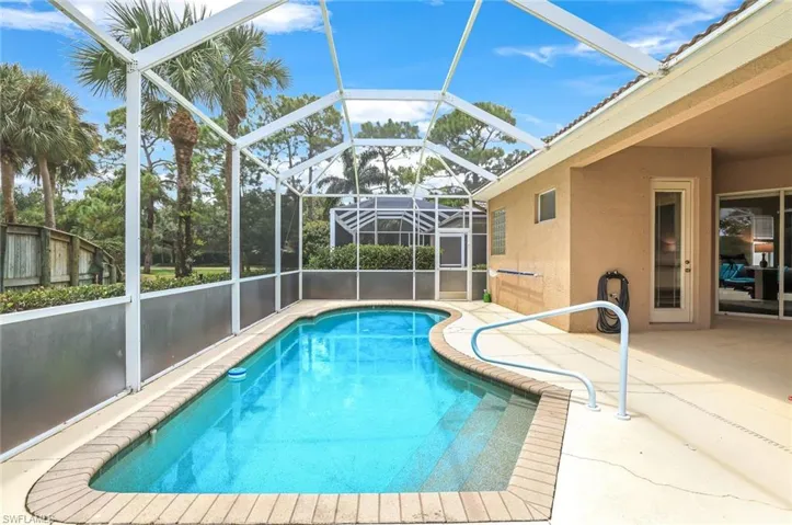View of swimming pool with a patio area and a lanai