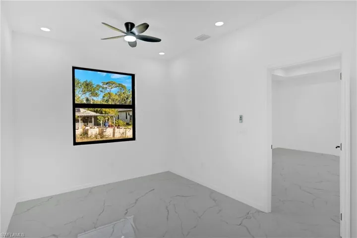 Unfurnished room with marble finish flooring, ceiling fan, and recessed lighting