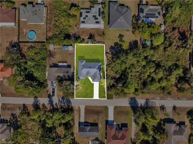 Aerial view of residential area with property boundaries highlighted