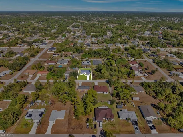 Aerial view of property's location featuring nearby suburban area
