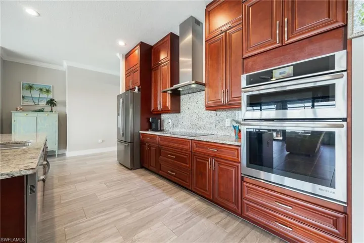 Cherry Cabinets with Stainless Jenn Air Appliances including induction cooktop, convection wall oven and microwave