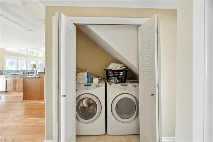 Laundry area featuring separate washer and dryer and light wood-style floors