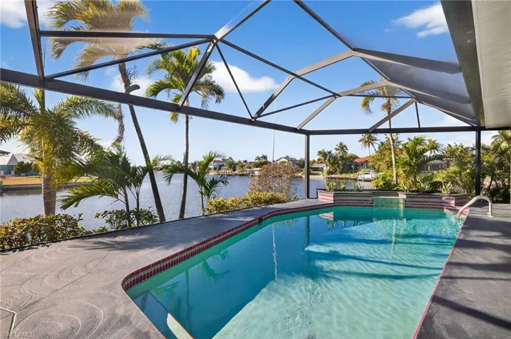 Outdoor pool with a sunroom, a water view, a lanai, and a patio