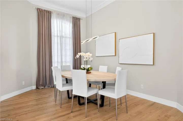Dining area featuring crown molding and light wood-style flooring
