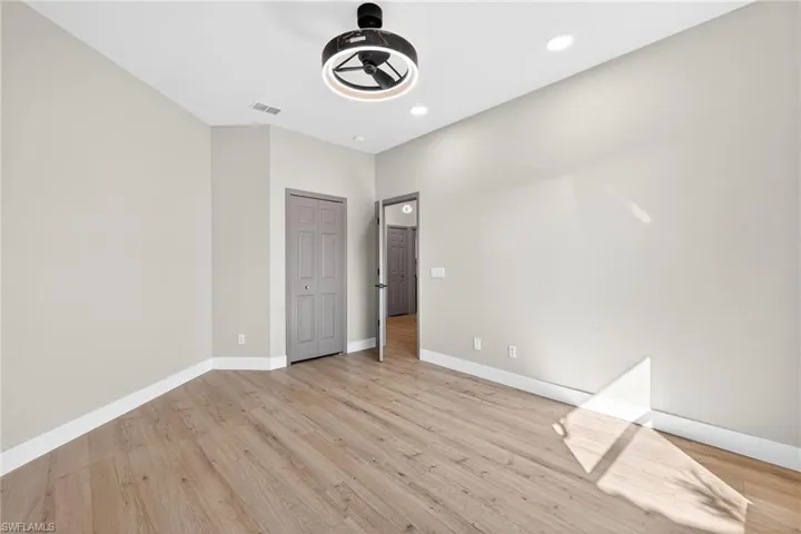 Unfurnished bedroom featuring light wood finished floors, recessed lighting, a closet, and a ceiling fan