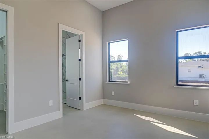Unfurnished bedroom featuring a walk in closet and a closet
