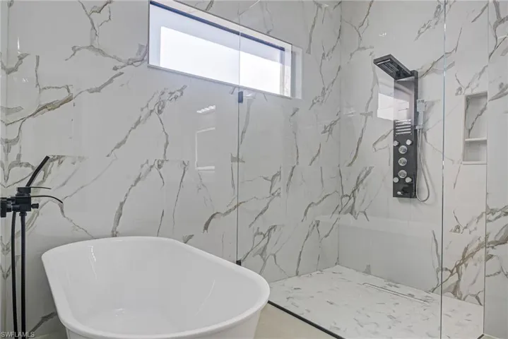 Bathroom with shower with separate bathtub