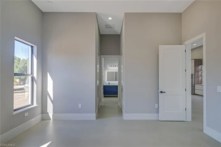 Unfurnished room featuring a towering ceiling