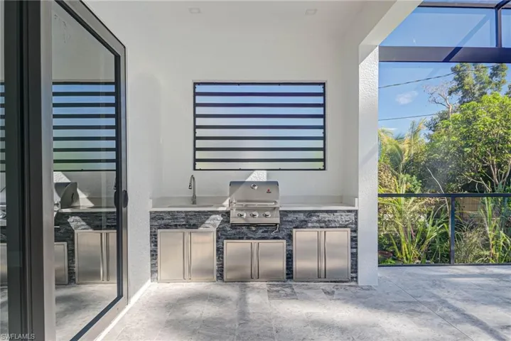 View of patio featuring sink, grilling area, and an outdoor kitchen