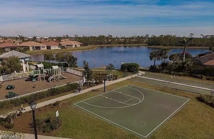View of basketball court featuring community basketball court and a water view