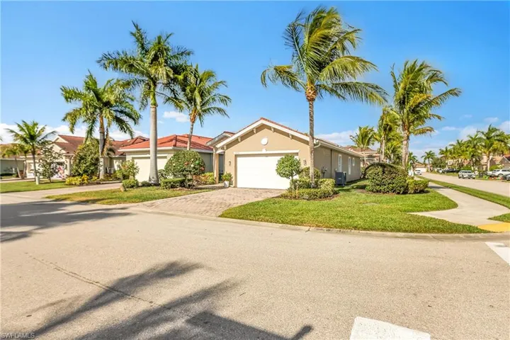 Ranch-style house with a front lawn, decorative driveway, a garage, stucco siding, and a residential view