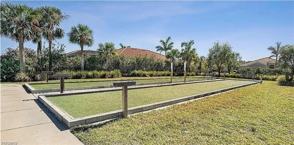 View of home's community featuring a game area and a yard