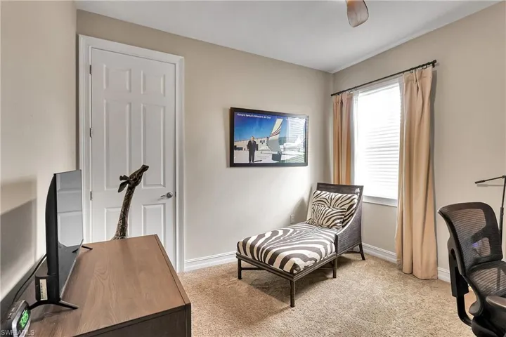 Office featuring light carpet8 and a ceiling fan