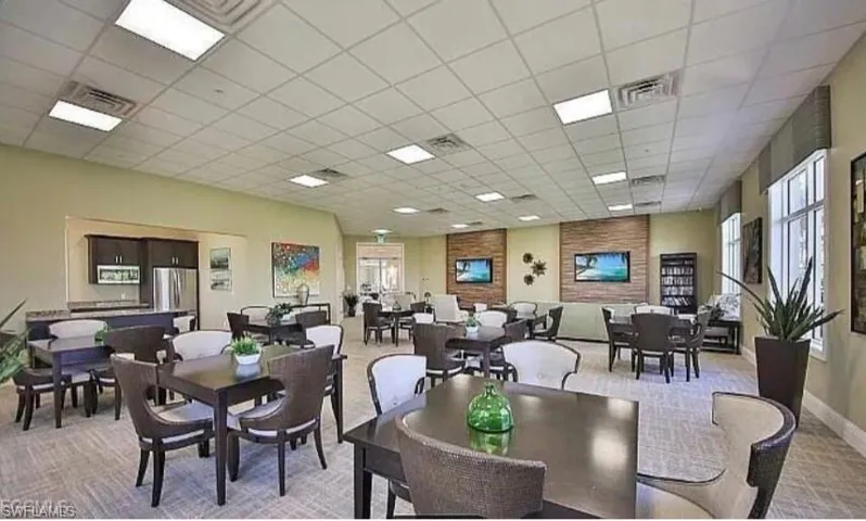 Dining space featuring a paneled ceiling and light carpet