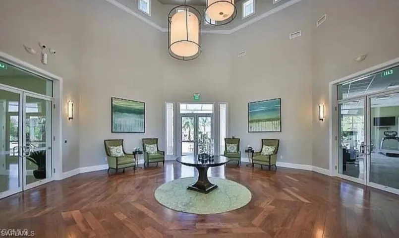 Building lobby featuring a towering ceiling and ornamental molding