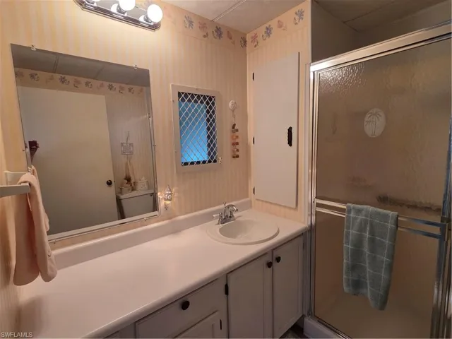 Full bathroom with walk-in shower conveniently located off the kitchen.