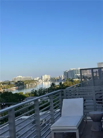 Balcony with a water view and a view of city
