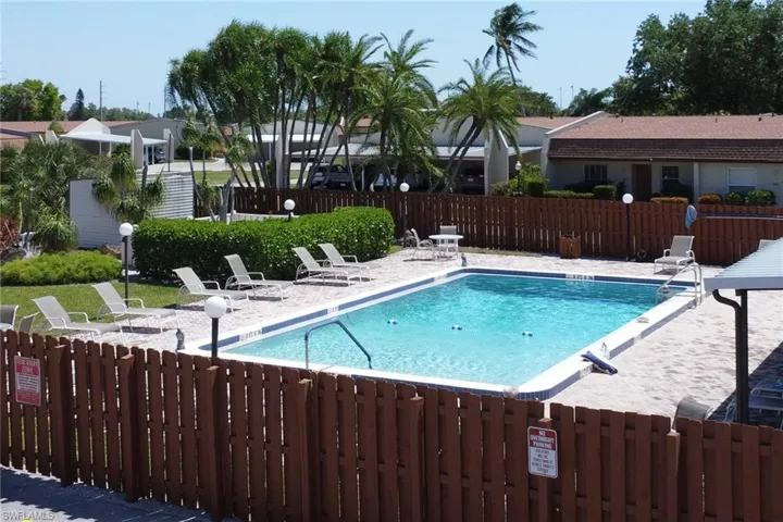Rectangular swimming pool surrounded by a paved deck