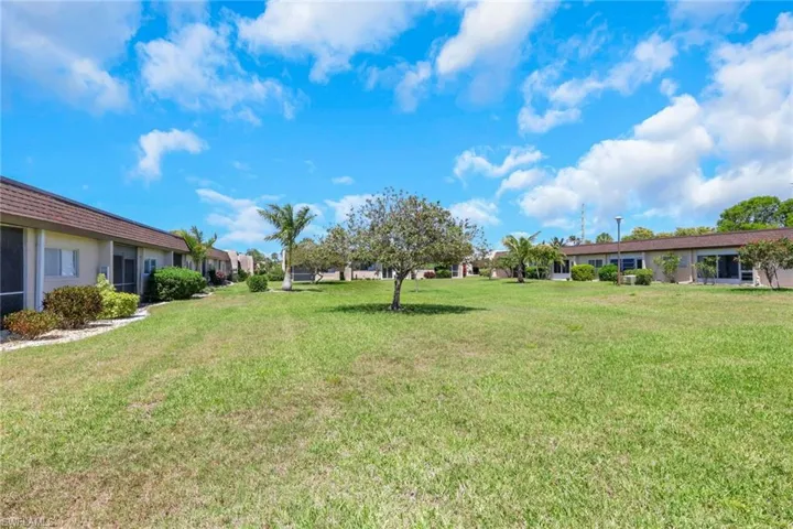 Expansive green space featuring mature trees and established landscaping