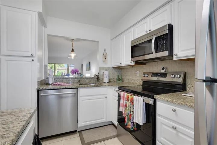 White shaker-style cabinetry with granite countertops