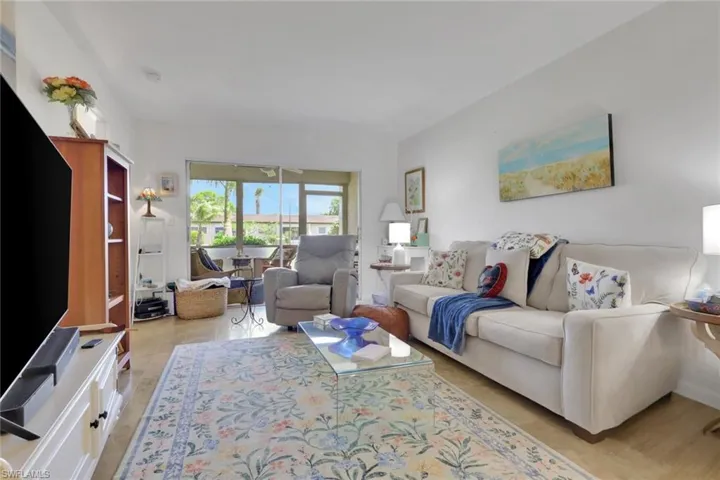 Bright living area with wood-finish flooring and white walls