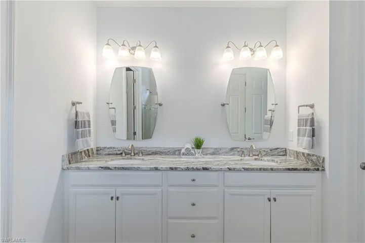 Primary Bathroom featuring Dual Vanity sinks & granite counters