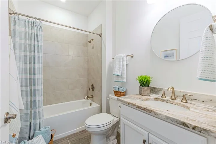 Guest Bathroom with tub and granite vanity