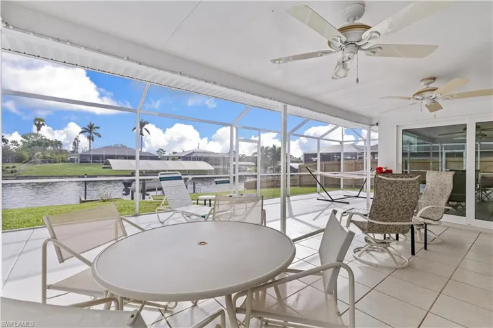 Large Lanai under cover with view of boat lift and canal.