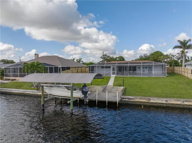 View from the wide canal of the boat lift and cement dock.